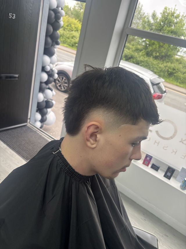 Textured crop with a mid skin fade at JD&Co Barbershop