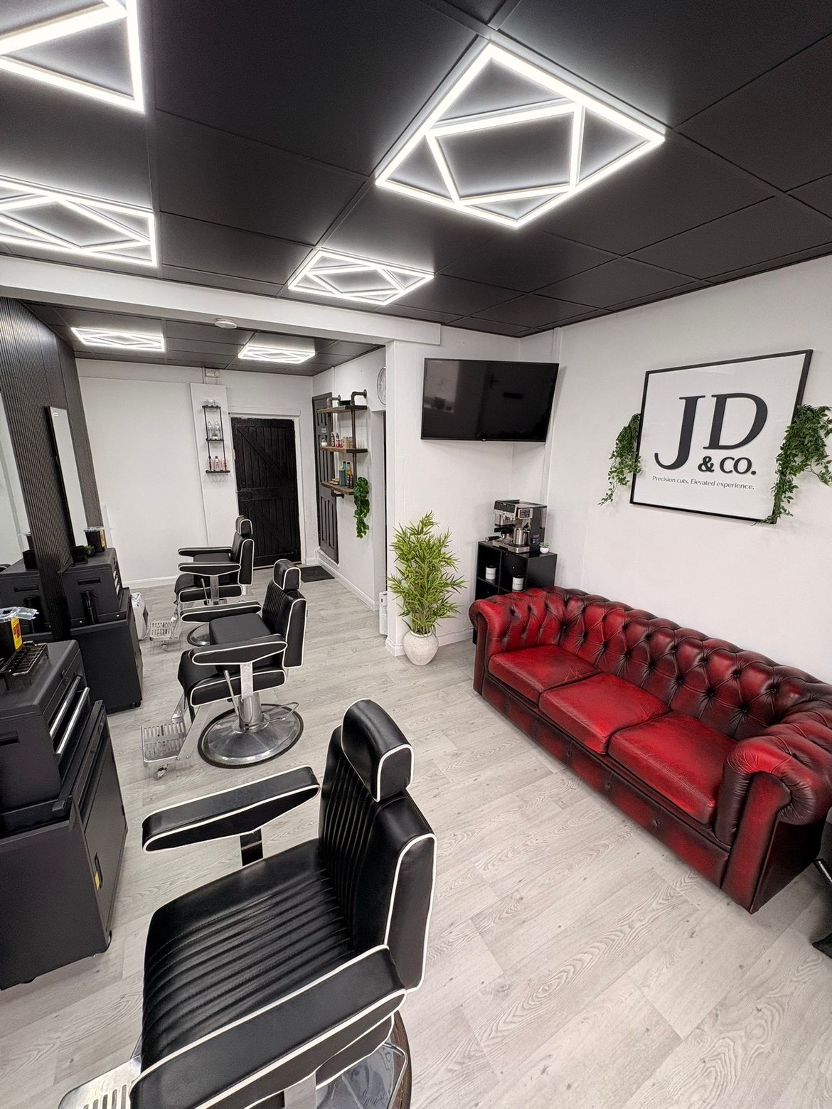 The JD&Co Barbershop interior with red leather seating